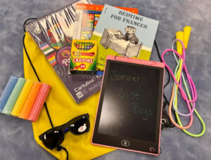 Side walk chalk, sunglasses, jump rope, crayons, writing tablet, early reader books